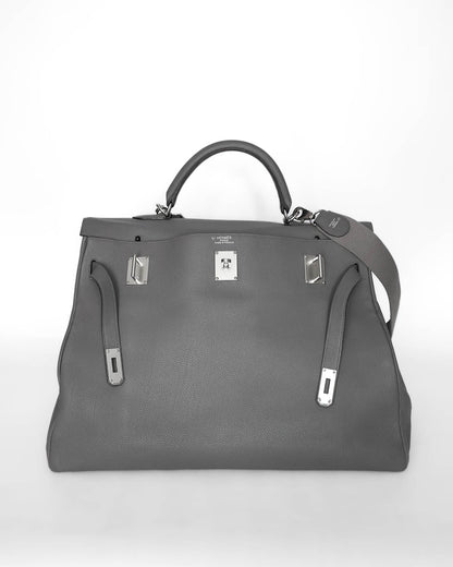 Rare Hermès HSS Kelly 50 Voyage travel bag in elephant‑grey matte Clémence leather, VIP‑commissioned (HSS stamp) with iconic turn‑lock and internal zipped & slit pockets