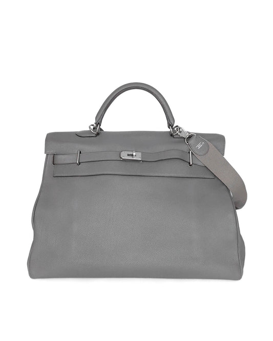 Hermès Kelly 50 Voyage in Gris Etain Clémence leather (2018), with tonal special‑order cotton strap and interior zipped & slit pockets